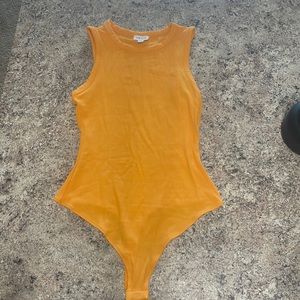 Tangerine thong body suit. Worn once